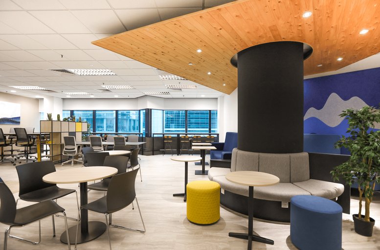 Spacious communal lounge at 80, Robinson Road featuring a wooden ceiling canopy and colourful stools.
