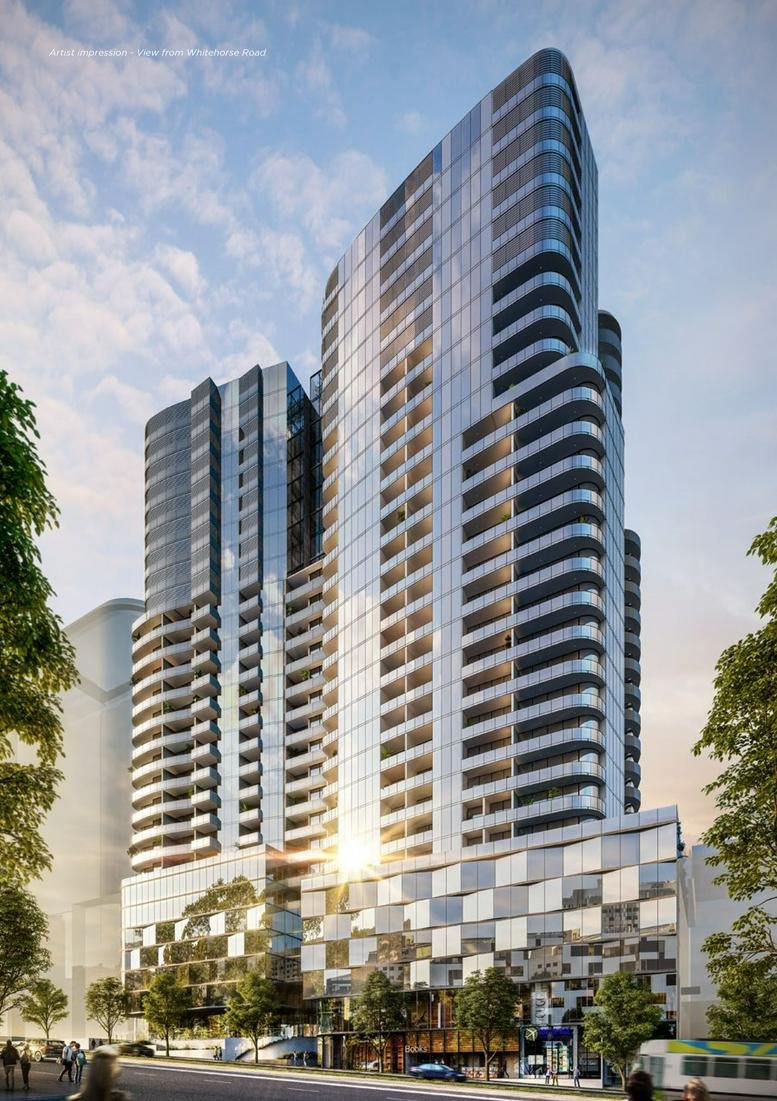 Exterior view of modern high-rise building with glass facade and balconies.