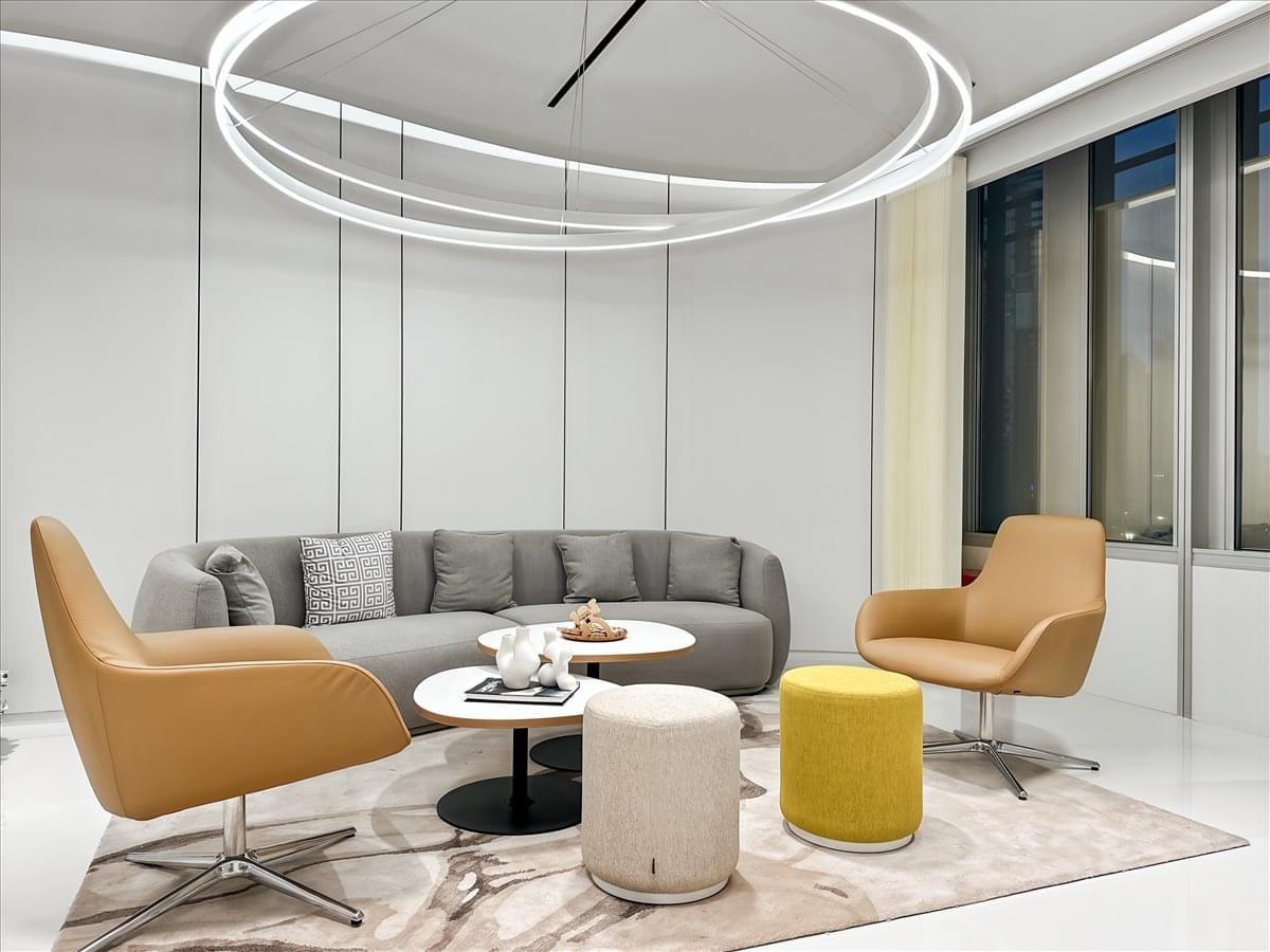 Curved marble and wood reception desk under designer pendant lighting at Jin Mao Tower.
