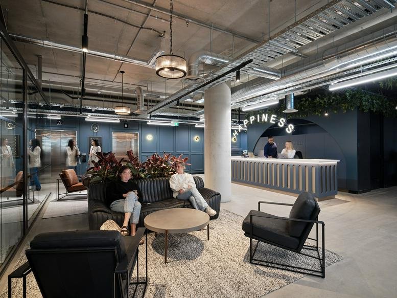 Lobby and reception area of 88 Jolimont Street, East Melbourne with lounge seating and industrial ceilings.