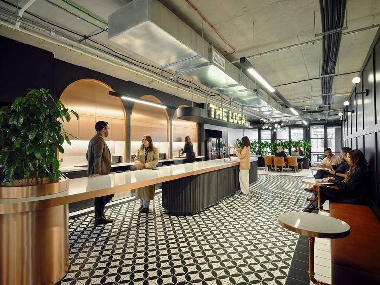 Spacious communal bar area with warm wood arches and patterned tile flooring at 88 Langridge Street.