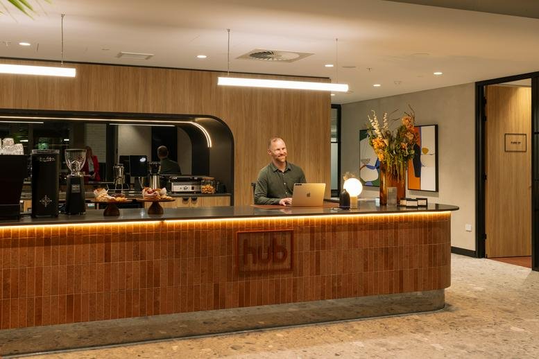 Reception area at 88 O’Connell Street, Adelaide, South Australia with a wooden desk and warm lighting.