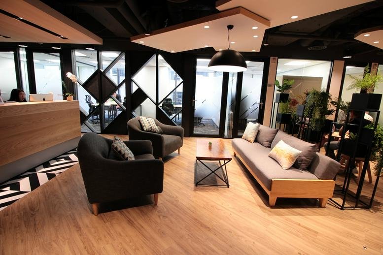Modern lobby at 8F & 11F Admiralty Centre Tower 2 with designer lounge seating and warm wood accents.