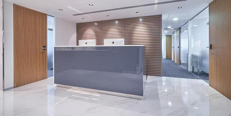 Modern lobby at BOC Group Life Assurance Tower with a sleek grey reception desk and marble floors.