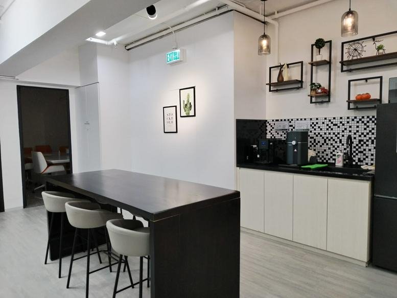 Communal kitchen area at Kato Factory Building with a high breakfast bar and black and white tiled backsplash.