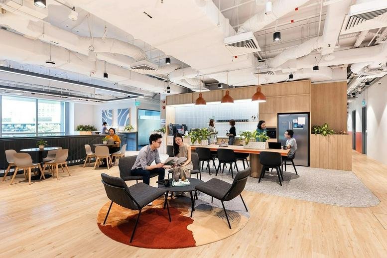 Spacious communal lounge with diverse seating and warm wood floors at 9 North Buona Vista Drive.