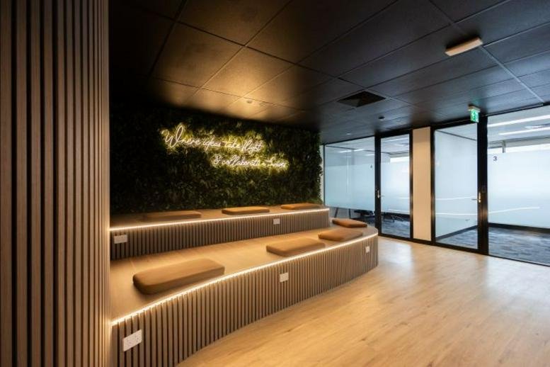 Modern lobby at 90 Phillip Street, Level 3, Parramatta featuring tiered wooden seating and a green feature wall.