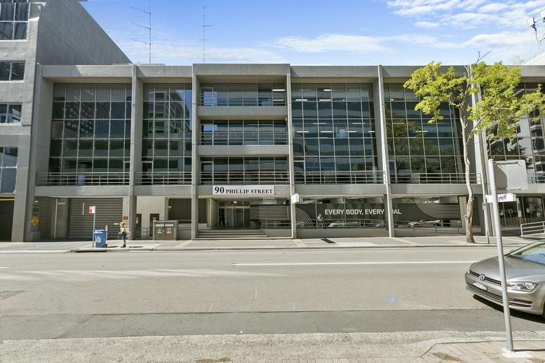 Street-level view of the multi-story glass facade building at 90 Phillip Street.