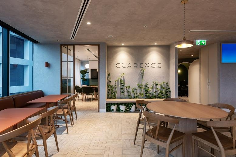 Reception area at 95 North Quay, Brisbane, Queensland with wood-slat walls, indoor plants and dining tables.