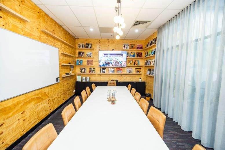 Meeting room at 95B Station Street, Level 1, Penrith, Sydney with a long white table and light wood paneled walls.