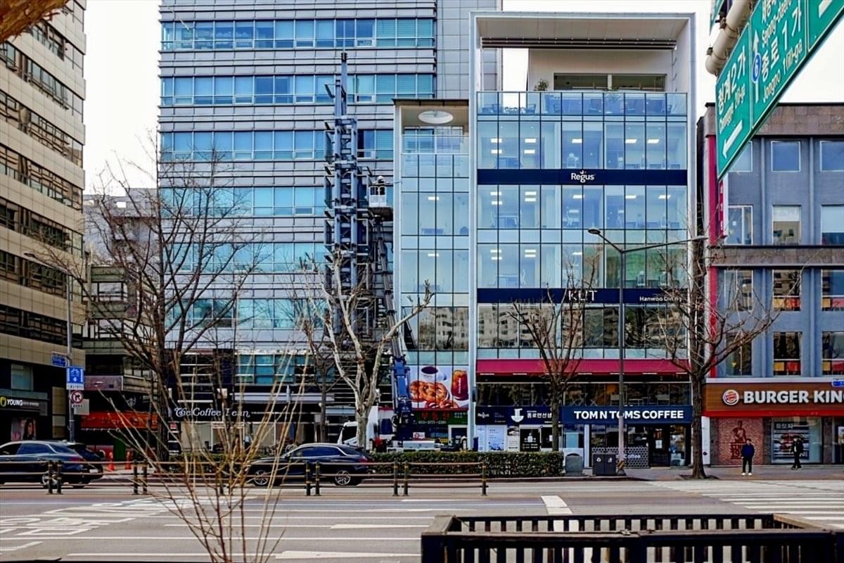 Exterior view of the glass-facade Hanol Tower building in an urban setting.