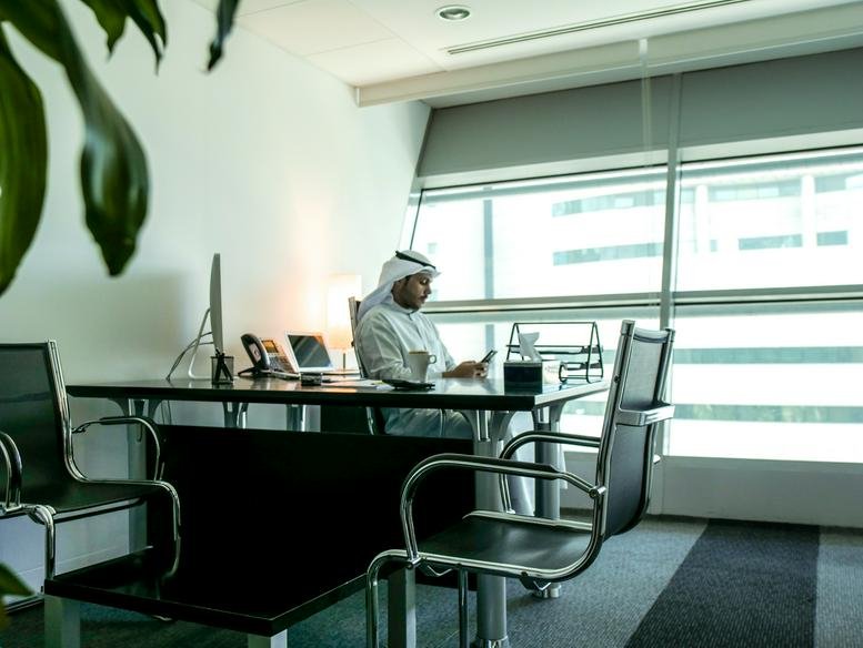 A private executive office at Ahmad Al Jaber Street, Sharq, Kuwait City with large windows and city views.