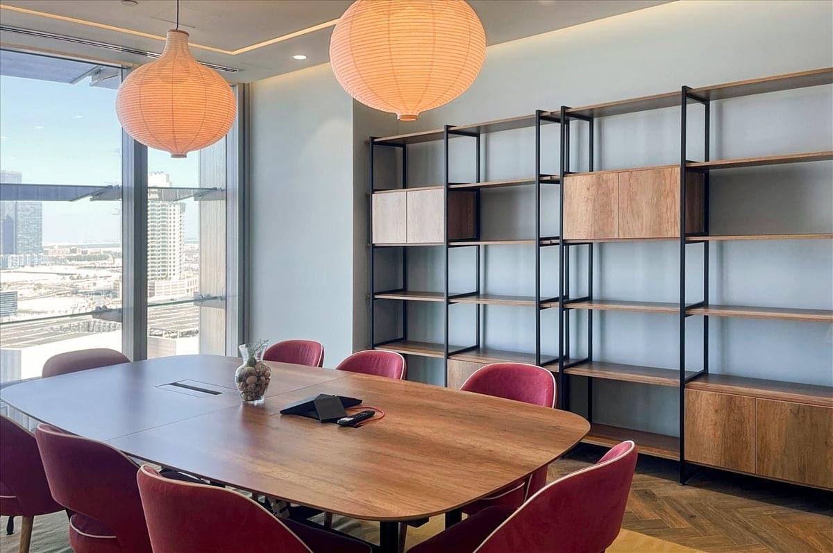 Detailed view of the Al Maqam Tower boardroom featuring modern shelving and wooden finishes.