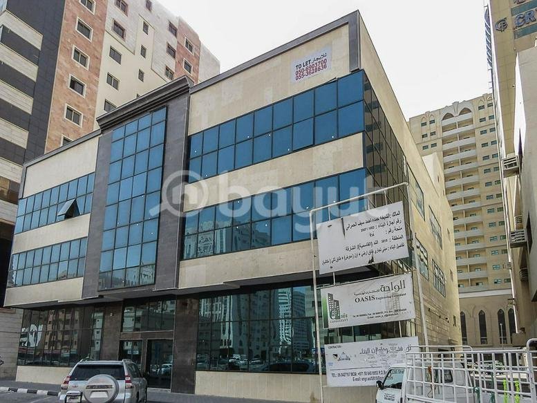Exterior view of the glass-facade building at Al Nad Hay Al Qasimia Sharjah.