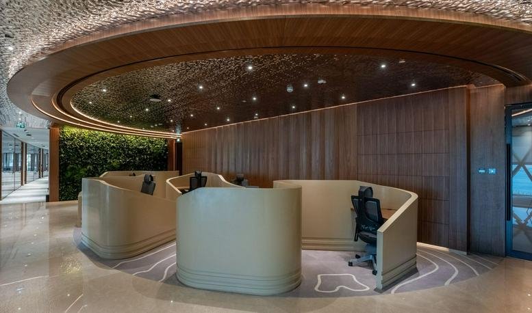 The sleek, curved reception area of Aldar HQ, Level 3, Al Raha Beach, Abu Dhabi.