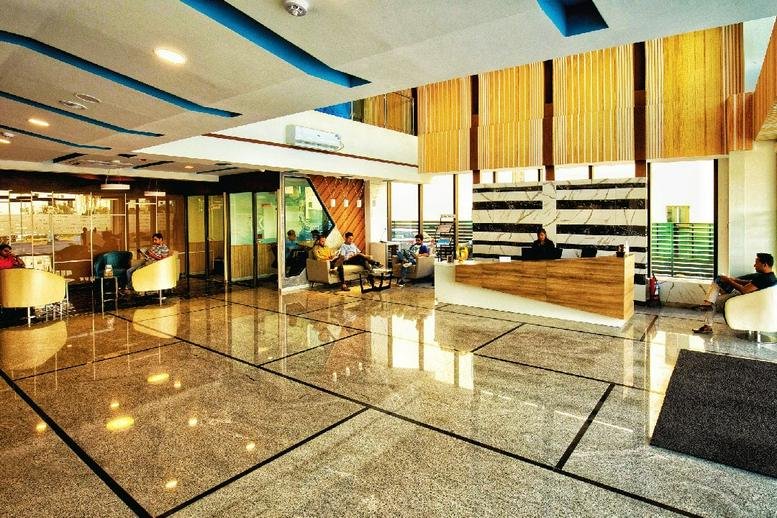 Polished reception and lobby area at AMR Tech Park showing the front desk and seating.