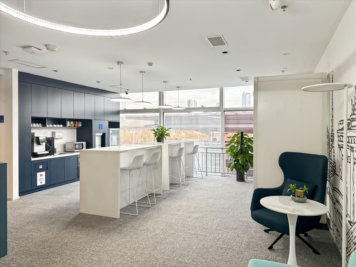 Spacious communal breakout area at Aocheng, 3rd Floor, Nankai District, Tianjin with a modern kitchen and bar seating.