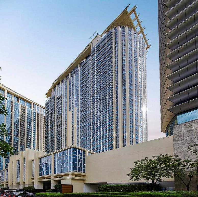 Exterior view of the modern glass-facade Athenee Tower in Bangkok.
