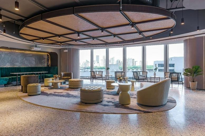 Spacious sunlit lounge at Ayala Triangle Gardens Tower 2 with circular ceiling feature and city views.
