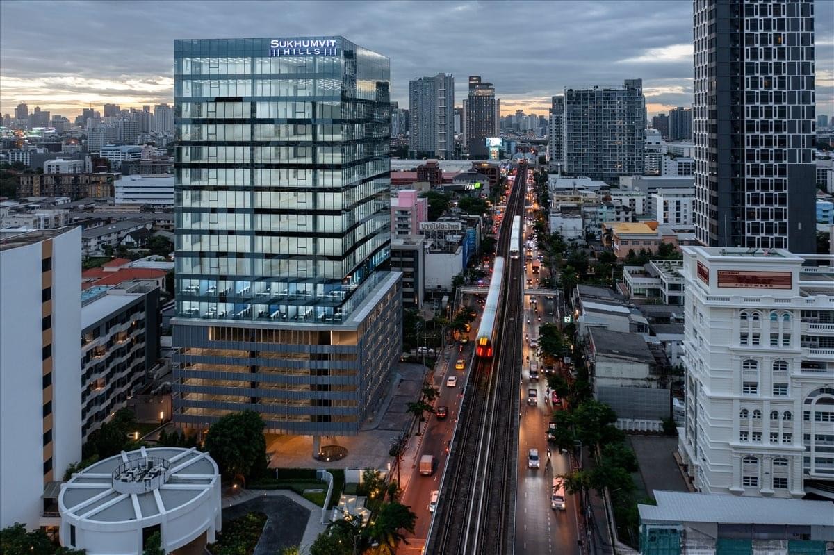 Exterior view of the glass-facade Bangkok Ploenchit Centre Co. Ltd building at dusk.