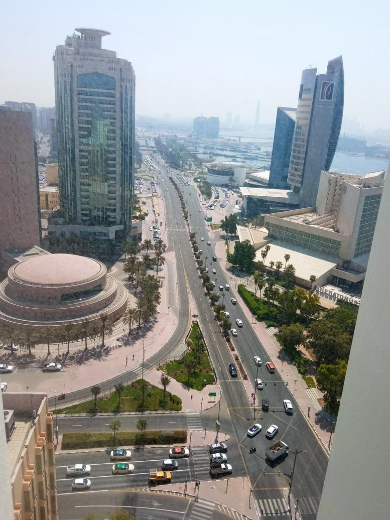 Aerial view of the Al Masraf Tower and surrounding city skyscrapers.