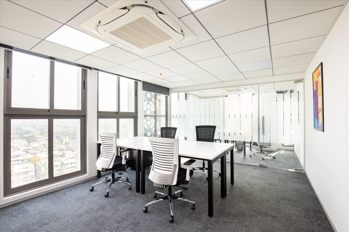 Bright private office at 11th Floor, Block-A, Keshavbaug, Vastrapur with four workstations and large windows.