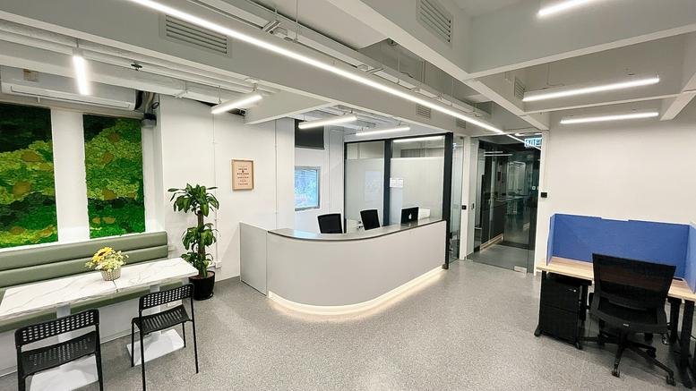 Curved white reception desk in a modern office with integrated ceiling lighting.