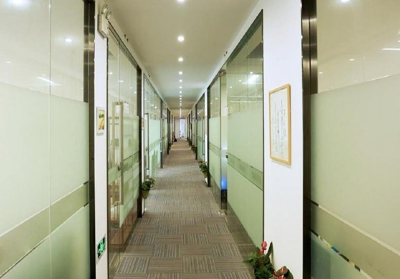 Long bright hallway at Building 1, United Venture Center with frosted glass office partitions.