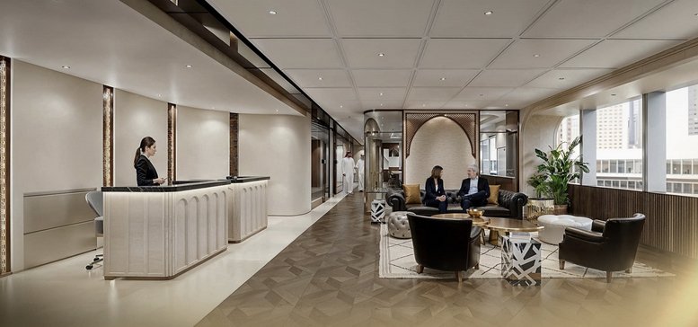 Elegant reception area at Level 7, Building 3. 09, Al Aqiq with a curved desk and soft lounge seating.