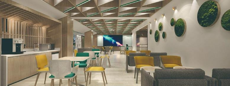 Spacious communal lounge at Wuhan Creativity World with colorful seating and plant wall art.