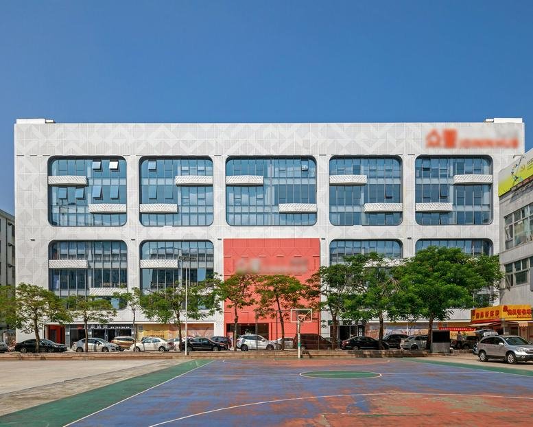 Exterior view of the white facade and window grid of Building J, Jianshe Industrial Park.