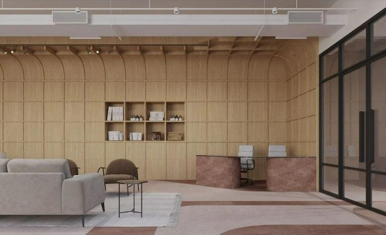 Reception lobby at Bund Garden Road, Koncord Tower, Pune featuring a curved wood-paneled wall and modern desks.