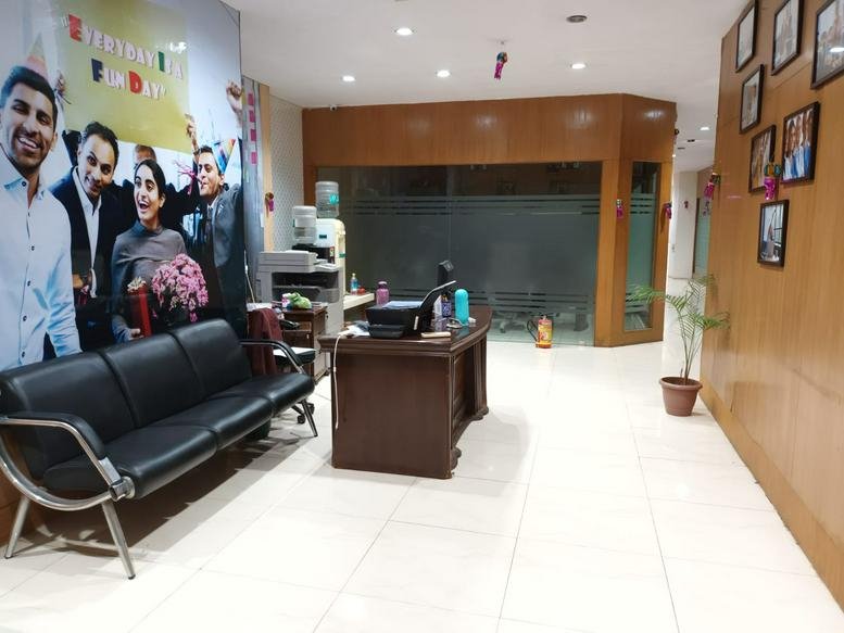 Reception area at Tower No. 7, Platform Floor, Sector 11, CBD Belapur, featuring a black sofa and large mural.
