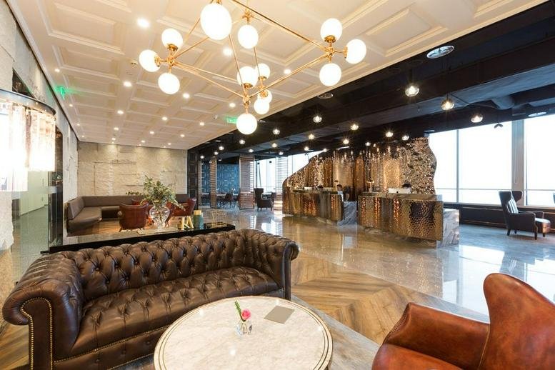 Spacious reception lounge at Chengdu IFS, Office Tower I, with leather sofas and a unique chandelier.
