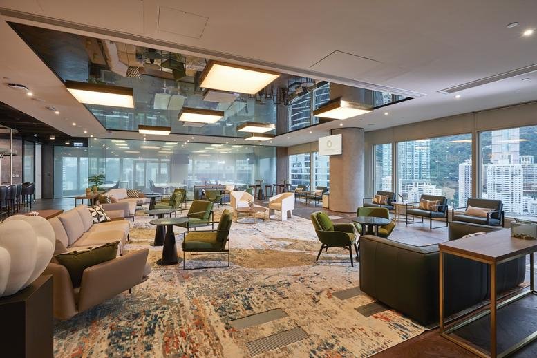 Spacious communal lounge with diverse seating, patterned rugs, and views at Cheung Kong Center.