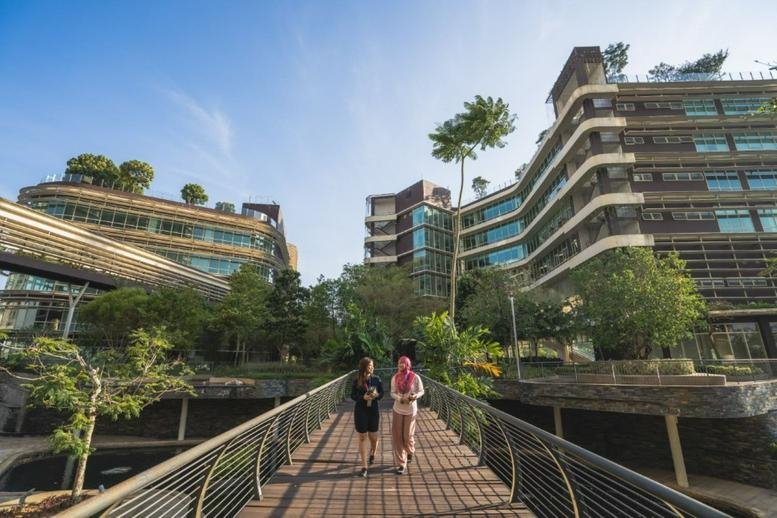 Exterior view of the multi-level glass and greenery-covered CIMB Leadership Academy.
