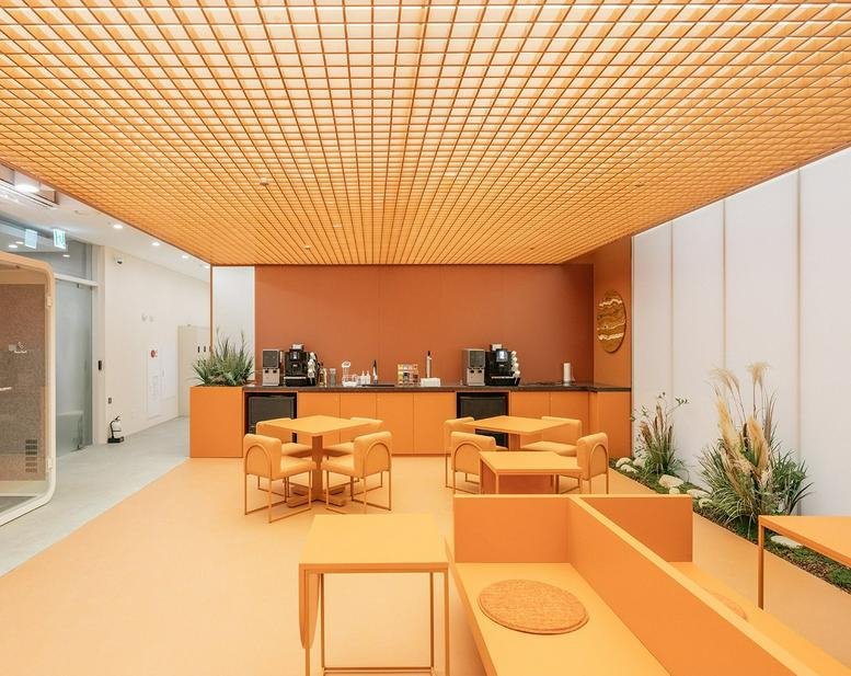 Spacious lounge at City Hall 2nd Branch, 89-20 Seosomun-ro, Seoul featuring vibrant orange tones and a grid ceiling.