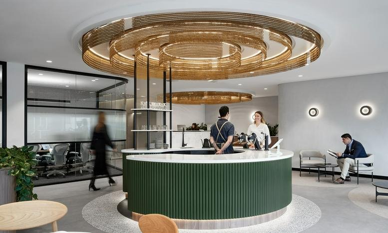 Elegant reception area with a curved green desk and a stunning gold tiered ceiling feature.
