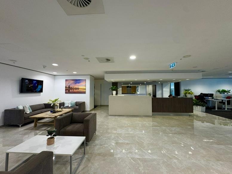 Spacious building lobby and reception area with comfortable lounge seating.