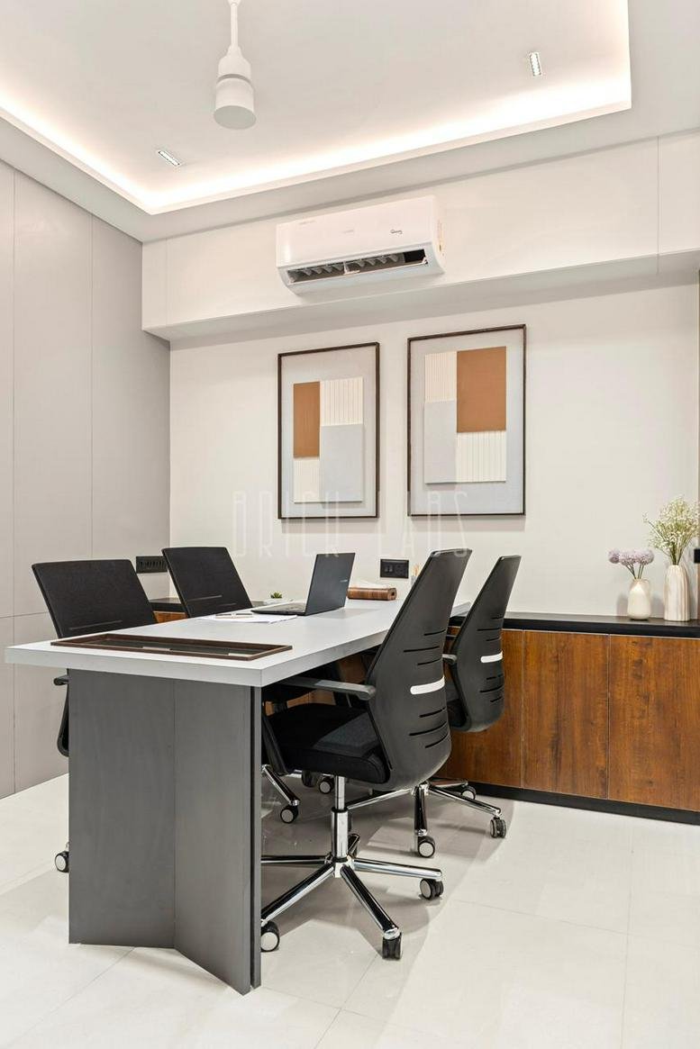 Meeting room at 401 Freedom Tower Aakashwani Chowk with gray conference table and modern office chairs.