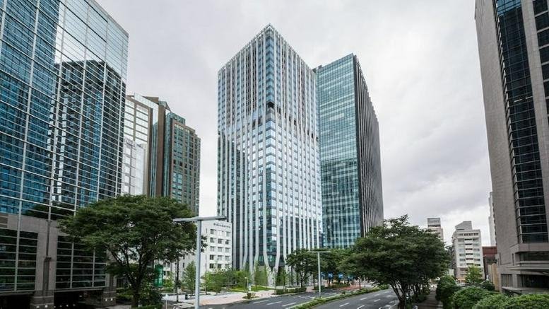 Modern glass exterior view of D-Tower 6-11-3 Nishishinjuku in Tokyo.