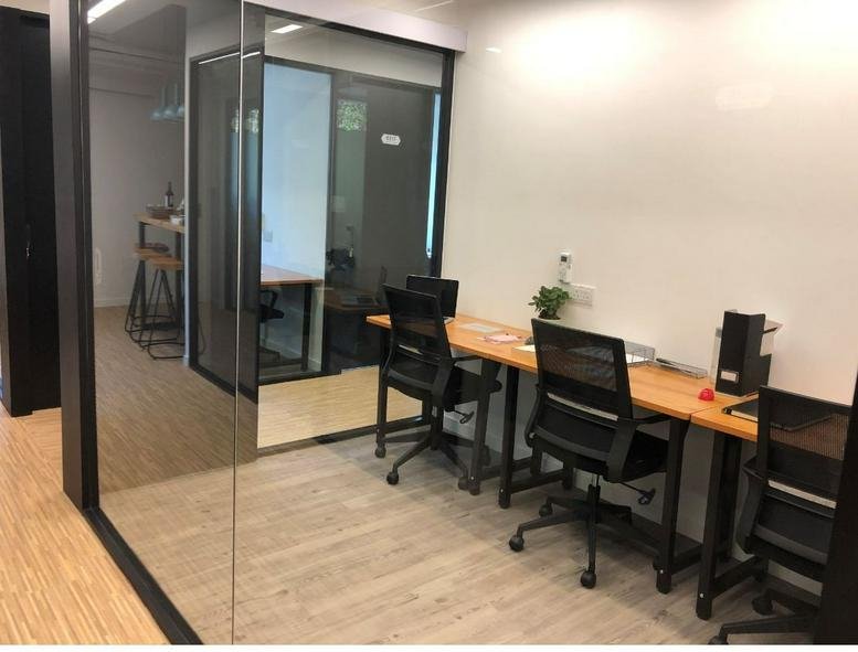 Modern office hallway at Derrick Industrial Building showing private glass suites.