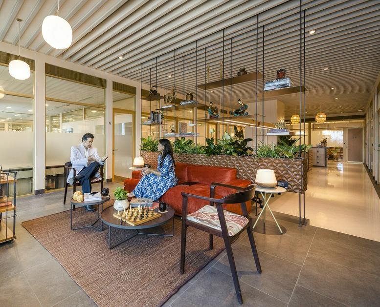 Spacious communal lounge at Dextrus, Crescenzo C 38/39, G-Block, Bandra Kurla Complex, Mumbai featuring warm lighting.