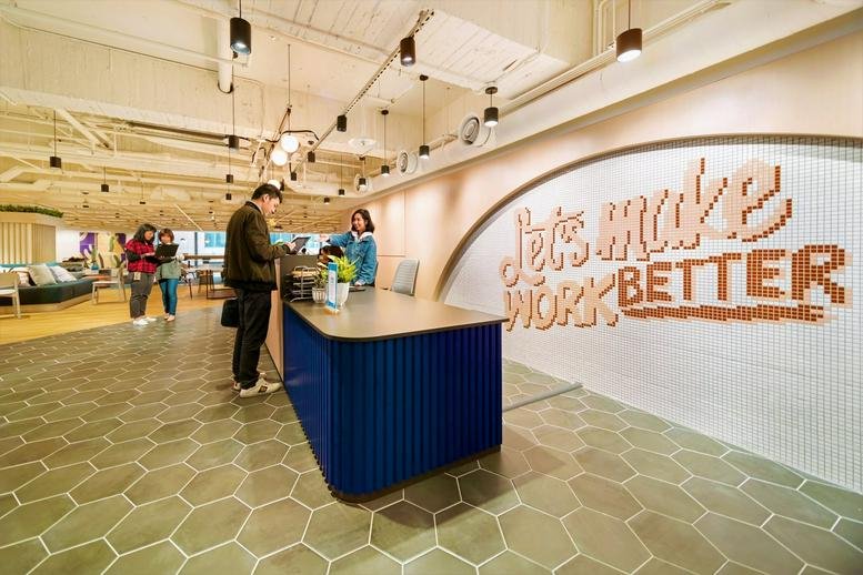 Reception area at Dian Shih, Levels 14 & 20, 206 Section 1 Keelung Road with a navy desk and wall art.