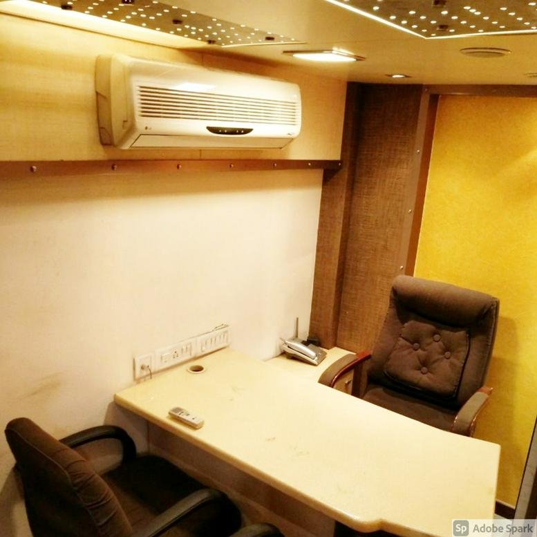 A private workspace at Crystal Plaza with a large wooden desk and a plush brown leather executive chair.