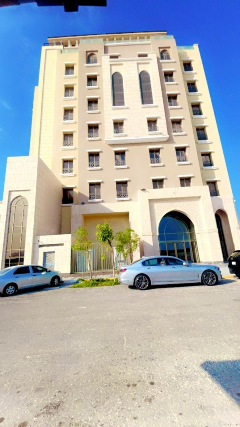 Exterior view of the EASTERN - ALkhobar building with traditional arched windows and light stone facade.
