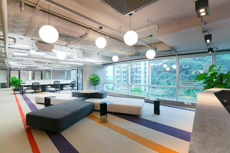 Spacious reception and lounge area at 15th Floor, Eastern Central Plaza with globe lights and colorful floor stripes.