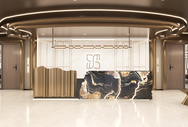 Elegant reception area featuring a luxury black marble desk with gold accents and a custom logo wall.