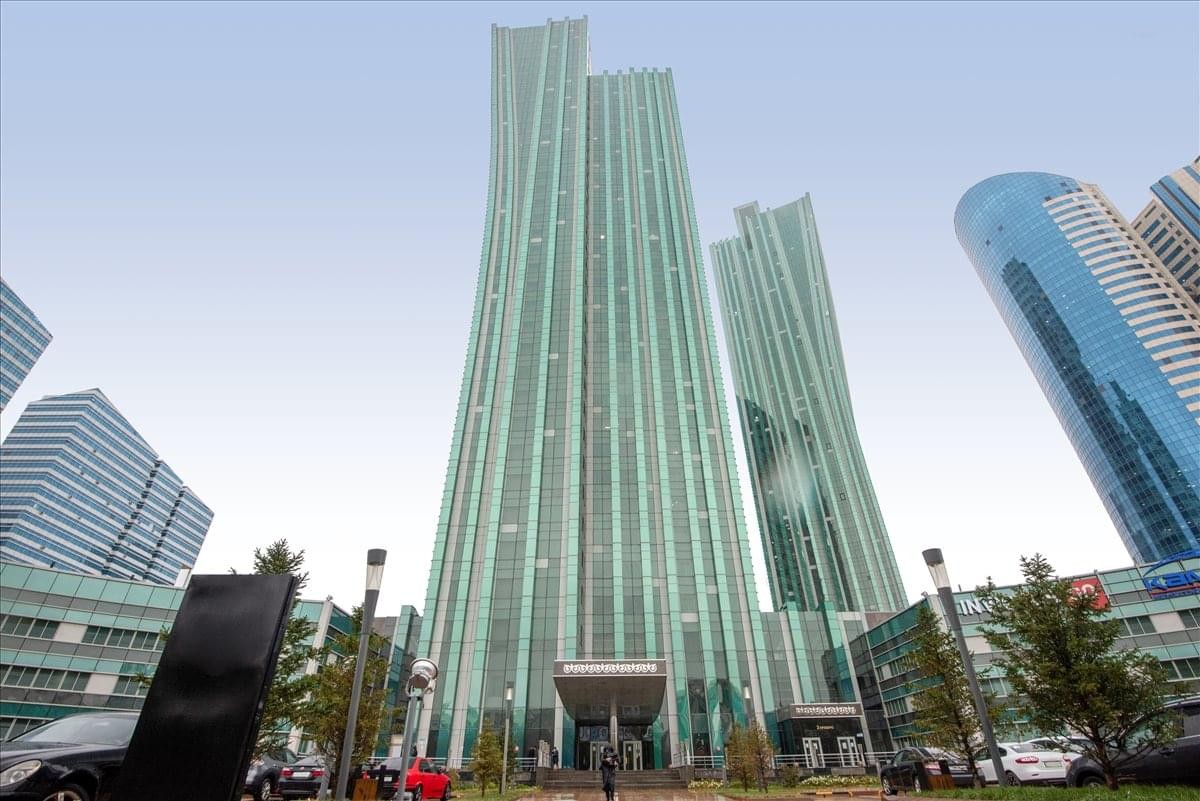 Exterior view of the soaring glass Emerald Tower with its distinctive curved design.