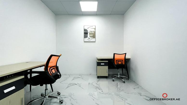 Internal two-person office at 2nd Floor Golden Tulip Downtown Hotel with orange ergonomic chairs.
